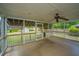 Screened-in porch with ceiling fan, offering a comfortable outdoor living space with views of the spacious backyard at 1707 Sharon Ave, Charleston, SC 29407