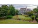 Scenic aerial view of the home with lush greenery, a well-manicured lawn and private backyard at 187 Ithecaw Creek St, Daniel Island, SC 29492