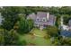 Expansive backyard offers a lush lawn, an outdoor lounge area, and a firepit area, surrounded by mature trees at 187 Ithecaw Creek St, Daniel Island, SC 29492