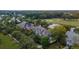 Scenic aerial view of homes nestled among lush greenery and a golf course with a pond at 187 Ithecaw Creek St, Daniel Island, SC 29492