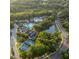Aerial view of resort featuring multiple pools, tennis courts, and lush landscaping at 187 Ithecaw Creek St, Daniel Island, SC 29492