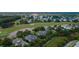 Aerial view of a neighborhood with homes nestled along a golf course and waterway at 187 Ithecaw Creek St, Daniel Island, SC 29492