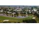 Breathtaking aerial view of waterfront community with homes along a golf course and pond at 187 Ithecaw Creek St, Daniel Island, SC 29492