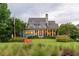 Stunning back exterior with a sprawling lawn, mature trees and beautiful screened in porch at 187 Ithecaw Creek St, Daniel Island, SC 29492
