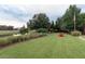 Spacious backyard with an open lawn featuring a fire pit and seating, great for outdoor gatherings at 187 Ithecaw Creek St, Daniel Island, SC 29492
