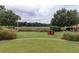 Enjoy outdoor living in this backyard featuring lush landscaping and serene golf course views at 187 Ithecaw Creek St, Daniel Island, SC 29492
