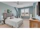 Bright, cozy bedroom with large window and neutral decor at 187 Ithecaw Creek St, Daniel Island, SC 29492