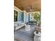 Inviting covered porch with stylish seating, including a swing, perfect for relaxing outdoors at 187 Ithecaw Creek St, Daniel Island, SC 29492