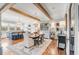Open concept dining and kitchen area with wood beams and hardwood flooring at 187 Ithecaw Creek St, Daniel Island, SC 29492