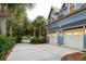 Charming home featuring a spacious two-car garage, a well-manicured lawn, and a long driveway, enhancing its appeal at 187 Ithecaw Creek St, Daniel Island, SC 29492