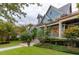 Beautiful home with manicured lawn, covered porch, and meticulously designed landscaping, creating an inviting outdoor space at 187 Ithecaw Creek St, Daniel Island, SC 29492