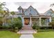 Stately home with manicured lawn, lush landscaping and a covered porch creating a grand entrance at 187 Ithecaw Creek St, Daniel Island, SC 29492