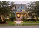 Charming two-story blue home with inviting front porch, manicured lawn, and mature trees at 187 Ithecaw Creek St, Daniel Island, SC 29492