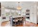 Modern white kitchen with center island, stainless steel appliances, and hardwood floors at 187 Ithecaw Creek St, Daniel Island, SC 29492