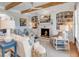 Bright living room with fireplace, wood beams, comfortable seating and stylish decor at 187 Ithecaw Creek St, Daniel Island, SC 29492