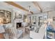 Living room with fireplace, ceiling fan, wood beams, and comfortable seating at 187 Ithecaw Creek St, Daniel Island, SC 29492