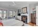 Bright bedroom with fireplace and view of the lake at 187 Ithecaw Creek St, Daniel Island, SC 29492