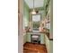 Home office with custom green cabinetry, built-in shelves, desk, and a window with a view at 187 Ithecaw Creek St, Daniel Island, SC 29492