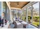 Sunroom with comfortable lounge chairs and a stylish rug, perfect for relaxation and enjoying the view at 187 Ithecaw Creek St, Daniel Island, SC 29492