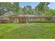 A brick home with a covered patio and a lush, green backyard, perfect for outdoor enjoyment at 204 Pointer Dr, Summerville, SC 29485