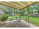 Covered patio area with seating in a spacious backyard with a storage shed at 204 Pointer Dr, Summerville, SC 29485