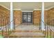 Inviting brick front porch featuring stately columns and a glass-paneled front door at 204 Pointer Dr, Summerville, SC 29485
