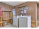 Functional laundry room with washer, dryer, and shelving for organized storage at 204 Pointer Dr, Summerville, SC 29485