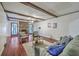 Cozy living room with exposed beams, hardwood floors and a stone fireplace at 204 Pointer Dr, Summerville, SC 29485