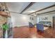 Spacious living room with a decorative stone fireplace, wood beams, and hardwood flooring at 204 Pointer Dr, Summerville, SC 29485
