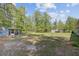 Expansive backyard featuring a screened-in porch and ample green space at 209 Cheyenne Rd, Summerville, SC 29483