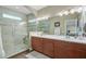 Modern bathroom featuring a glass-enclosed shower, double vanity, and neutral tile at 209 Cheyenne Rd, Summerville, SC 29483