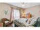 A relaxing bedroom featuring a floral-patterned quilt, a wicker chair, hardwood floors and soft natural light at 209 Cheyenne Rd, Summerville, SC 29483