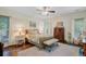 A serene bedroom features a wooden bed frame, soft carpet, and windows that offer natural light at 209 Cheyenne Rd, Summerville, SC 29483