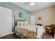 A well-lit bedroom with a floral-patterned quilt, hardwood floors, a ceiling fan and neutral walls at 209 Cheyenne Rd, Summerville, SC 29483