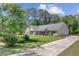 Beautiful one-story home with lush green lawn and long driveway on a sunny day at 209 Cheyenne Rd, Summerville, SC 29483