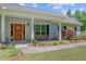 Close-up of a cozy front porch with decorative touches and house number 209 at 209 Cheyenne Rd, Summerville, SC 29483
