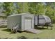 Exterior view of a shed and camper on a well-maintained lawn, offering storage and recreational possibilities at 209 Cheyenne Rd, Summerville, SC 29483