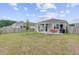 A green backyard with a fire pit, covered patio with seating, and fenced perimeter at 212 Rubles Ln, Moncks Corner, SC 29461