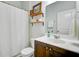 Bathroom featuring dark wood cabinets, a white shower curtain, and floating shelves at 212 Rubles Ln, Moncks Corner, SC 29461
