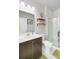 Bright bathroom featuring a vanity with dark wood cabinets and a shower with sliding glass doors at 212 Rubles Ln, Moncks Corner, SC 29461