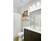 Bathroom featuring dark wood cabinets, a white shower curtain, and floating shelves at 212 Rubles Ln, Moncks Corner, SC 29461