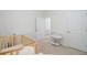 Bedroom featuring neutral carpet, a crib, and doorways leading to other rooms at 212 Rubles Ln, Moncks Corner, SC 29461