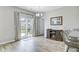Dining area with backyard access, stylish curtains, fireplace, and wood flooring at 212 Rubles Ln, Moncks Corner, SC 29461