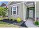 A close-up view of a home's attractive front yard with landscaping and welcoming entrance at 212 Rubles Ln, Moncks Corner, SC 29461