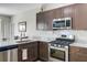 Modern kitchen features stainless steel appliances, granite countertops, and wood-look flooring at 212 Rubles Ln, Moncks Corner, SC 29461