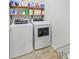 Laundry room featuring a washing machine and a dryer with storage shelves above at 212 Rubles Ln, Moncks Corner, SC 29461