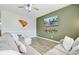 Living room boasts a large sectional sofa, ceiling fan, mounted TV, and stylish decor on a painted accent wall at 212 Rubles Ln, Moncks Corner, SC 29461