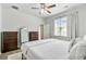 Main bedroom with a ceiling fan, two dressers, and a bright window with white curtains at 212 Rubles Ln, Moncks Corner, SC 29461