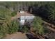Aerial view of the property showcasing the house, garage, and wooded surroundings at 2300 Bethera Rd # A, Bonneau, SC 29431