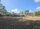 A house with a sprawling backyard, mature trees, screened porch, storage shed and play area at 2300 Bethera Rd # A, Bonneau, SC 29431